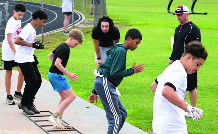 Young football players practice their skills at Baylor running back Caden Knighten’s first official football camp at the Wynnewood High School football field May 23. News Star photos by Don Coffey