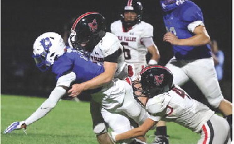 Panther defense makes a stop against the Dickson Comets during last Friday‘s season opener at Dickson. Photo by Mike Arie