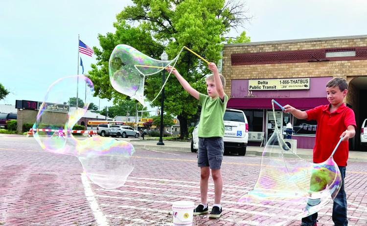 Children (and adults) attending the Fifth Friday Art Walk in downtown Pauls Valley June 30 had the opportunity to try their hand at making giant bubbles as part of the evening’s entertainment provided by Inspyral Circus Giant Bubbles. News Star photos by Suzanne Mackey