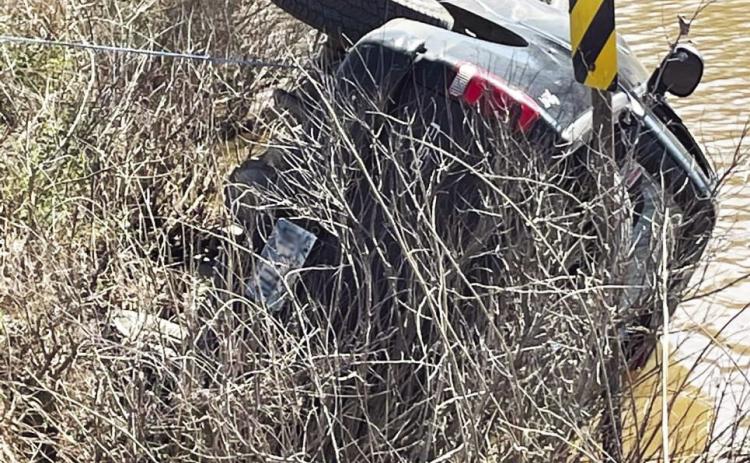 Pauls Valley firefighters used a winch line to keep this truck from rolling farther into Pauls Valley City Lake March 19 as crews worked to rescue the driver. Photo by Doug Walling/GCSO