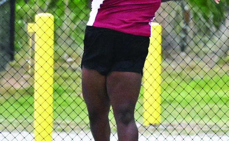 Wynnewood’s Annika Pittman throws a discus at the Wilson track meet last weekend. Pittman placed fourth in the discus.