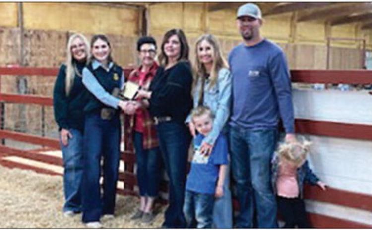 Raegan Howard was awarded the “Give it Your All Award” in memory of Dale and Toby Jones at the Maysville Local Livestock Show Feb. 23. Pictured left to right are Brittany Morphew, Raegan Howard, Judy Jones, Brenda Jones, Chipper Jones, Jaycie Jones, Justin Jones and Paxxley Jones. Courtesy photo