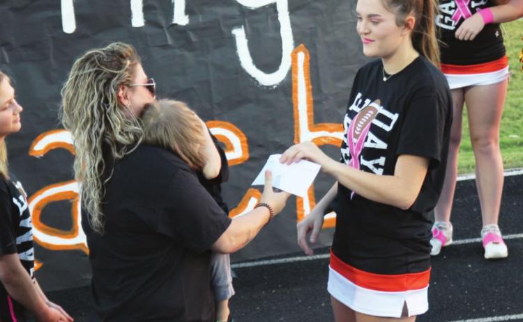 Lindsay cheer squad presents check to Largent family. Photo courtesy Sheryl Kochert