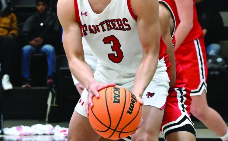 Panther senior Jorge Fabela tries to pass the ball during the Panthers’ district game against Sulphur Feb. 21.