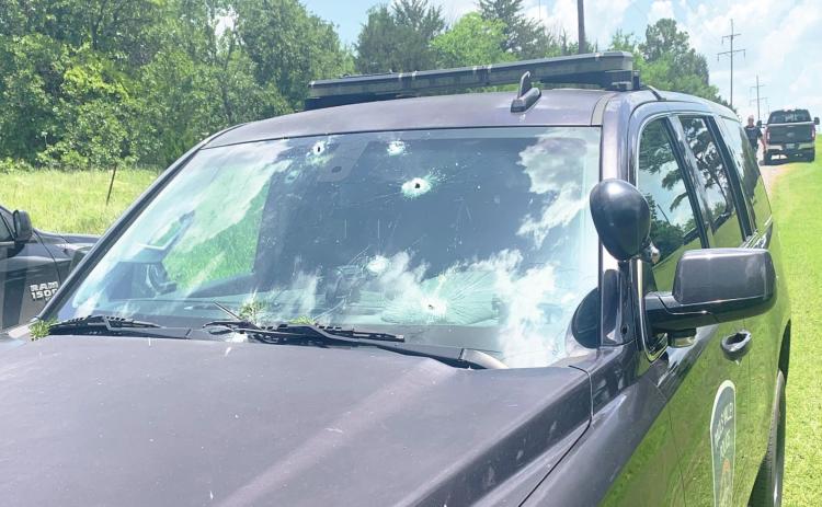 Multiple law enforcement vehicles were damaged during a standoff with an armed suspect Saturday afternoon. No officers were injured in the incident.