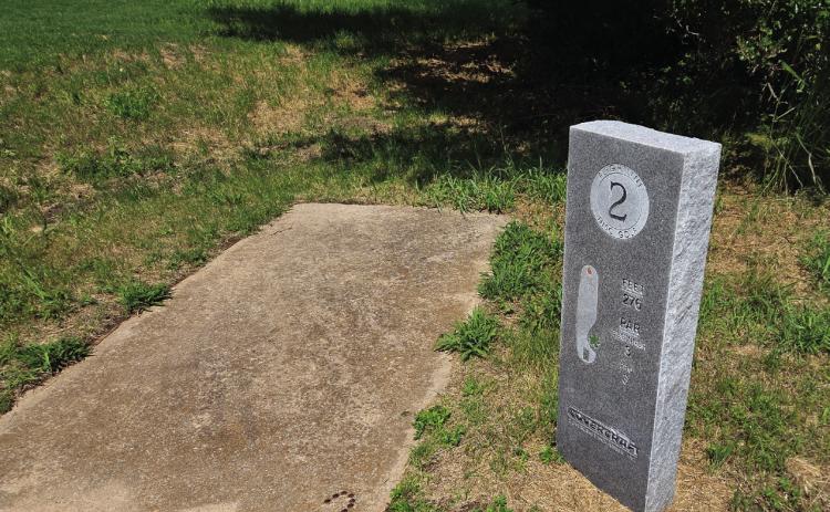 The tee at Hole 2 of the Flightline Golf Course includes a concrete pad and a granite marker specific to the hole. News Star photos by Jennifer Lindsey