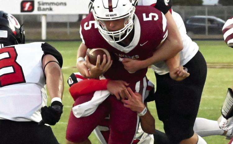 Wynnewood‘s Jake Everett drags the Indians for extra yards in the Savages’ win last week 17-14. News Star photo by Don Coffey