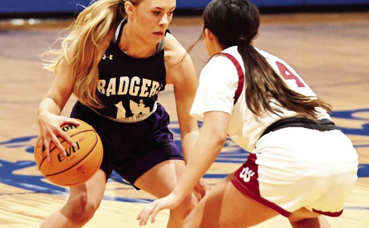 Elmore City-Pernell’s Valerie Riddle brings the ball down court against Wynnewood’s Jasmine Willey in the first round of the Bulldog Bash at Healdton. The Lady Badgers pulled a two point win 57-- 55 to move on to the second round of the winners bracket. News Star photo by Don Coffey